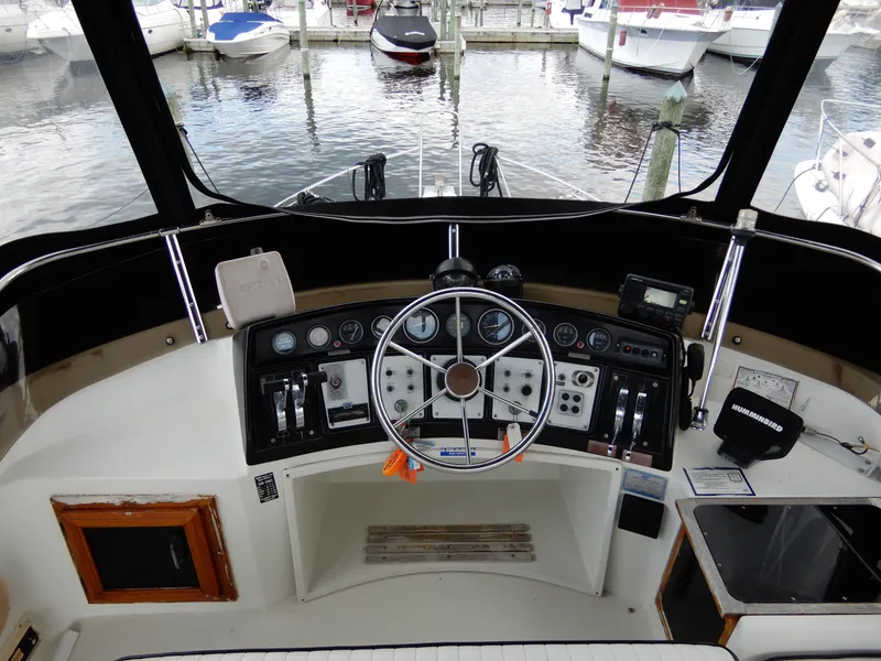 Slide: The Image of 1987 Carver 28 Mariner/Voyager helm with steering wheel and control panel at marina. - 14