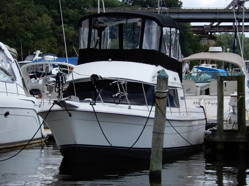 Slide: The Image of 1987 Carver 28 Mariner Voyager docked at a marina, surrounded by other boats. - 2