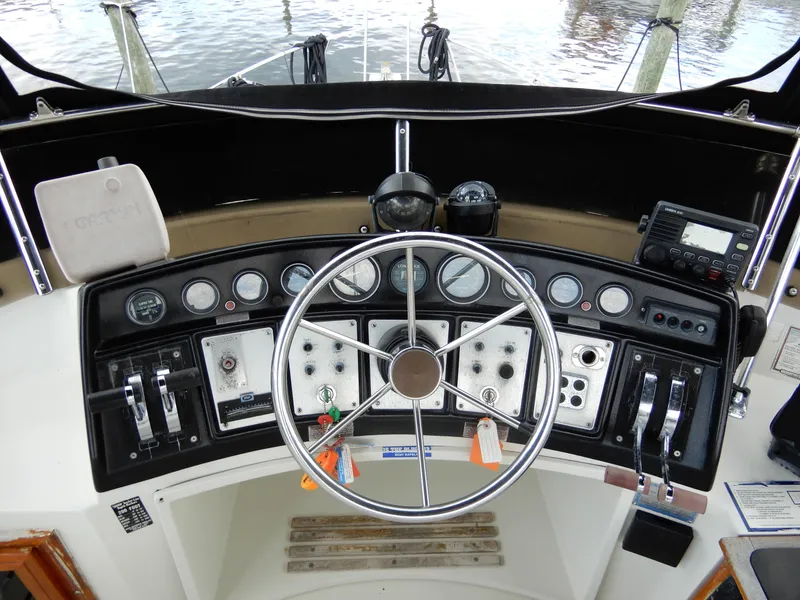 Slide: The Image of 1987 Carver 28 Mariner Voyager helm with steering wheel and control panel. - 23