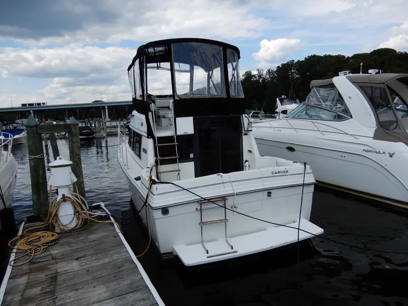 Slide: The Image of 1987 Carver 28 Mariner Voyager docked at marina under cloudy sky. - 3
