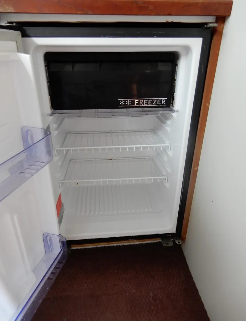 Slide: The Image of Empty refrigerator with freezer in 1987 Carver 28 Mariner Voyager boat. - 36