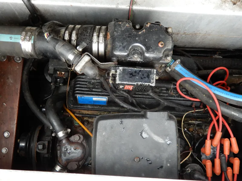 Slide: The Image of Engine compartment of a 1987 Carver 28 Mariner/Voyager boat, showing hoses and components. - 48