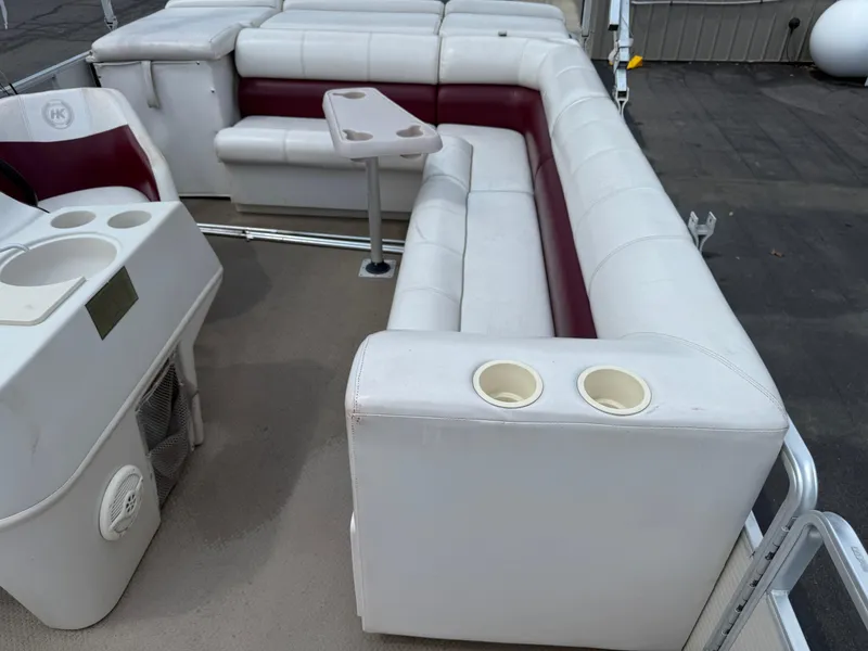 Slide: The Image of Interior of a 2000 Harris 200 Super Sunliner pontoon boat with white and maroon seating. - 11