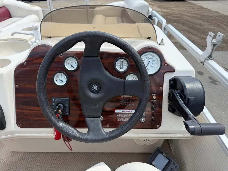 Slide: The Image of Steering wheel and dashboard of a 2000 Harris 200 Super Sunliner boat. - 15