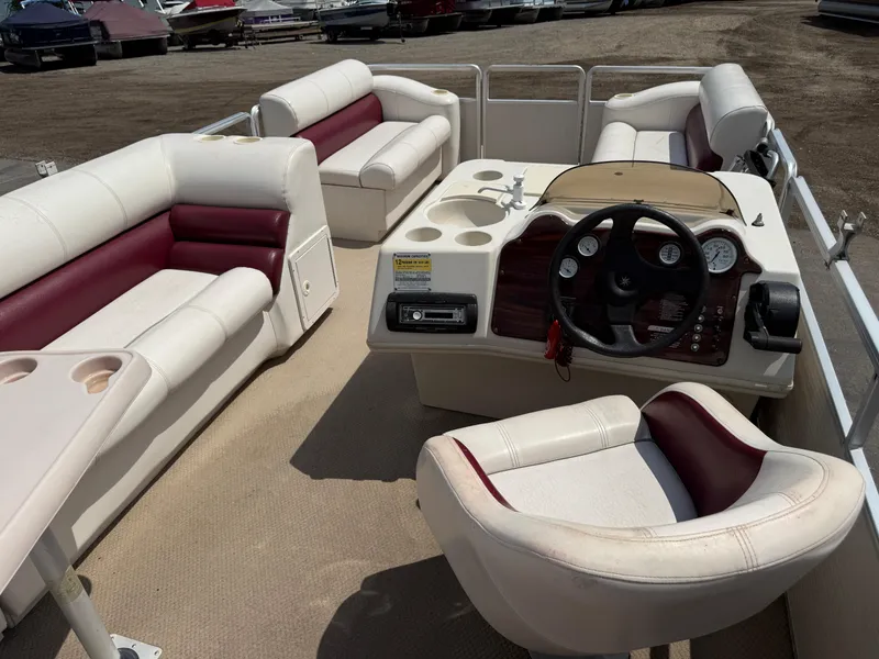 Slide: The Image of Interior of a 2000 Harris 200 Super Sunliner pontoon boat with white and maroon seating. - 16