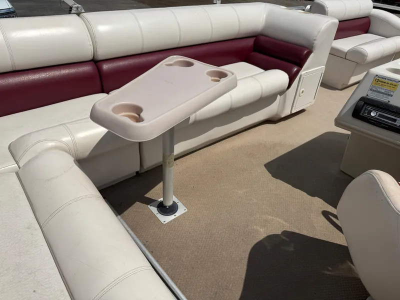 Slide: The Image of Interior of a 2000 Harris 200 Super Sunliner pontoon boat with beige and maroon seating. - 17