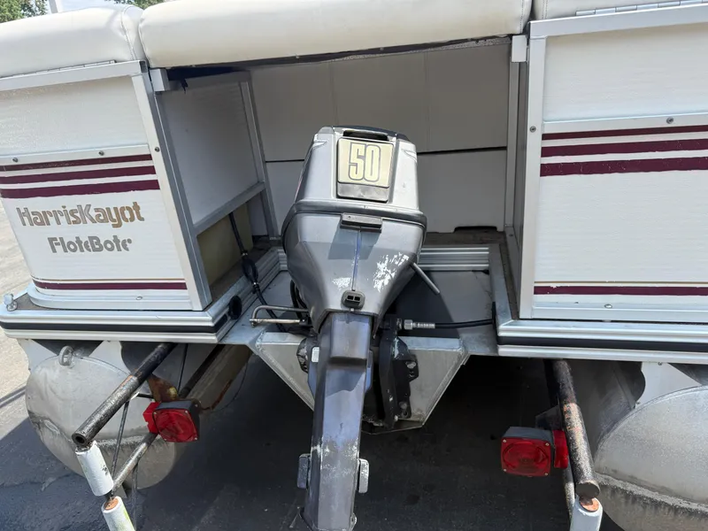 Slide: The Image of Rear view of a 2000 Harris 200 Super Sunliner pontoon boat with an outboard motor. - 5