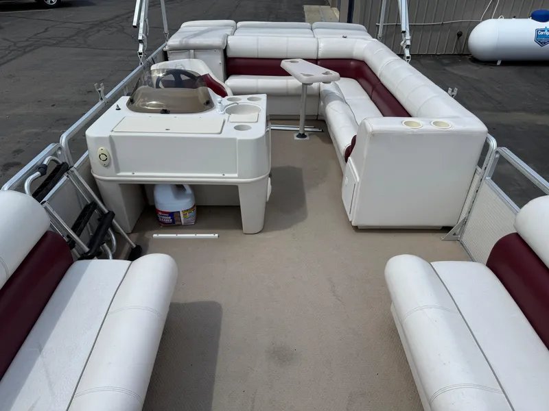 Slide: The Image of Interior of a 2000 Harris 200 Super Sunliner pontoon boat with white and maroon seating. - 6