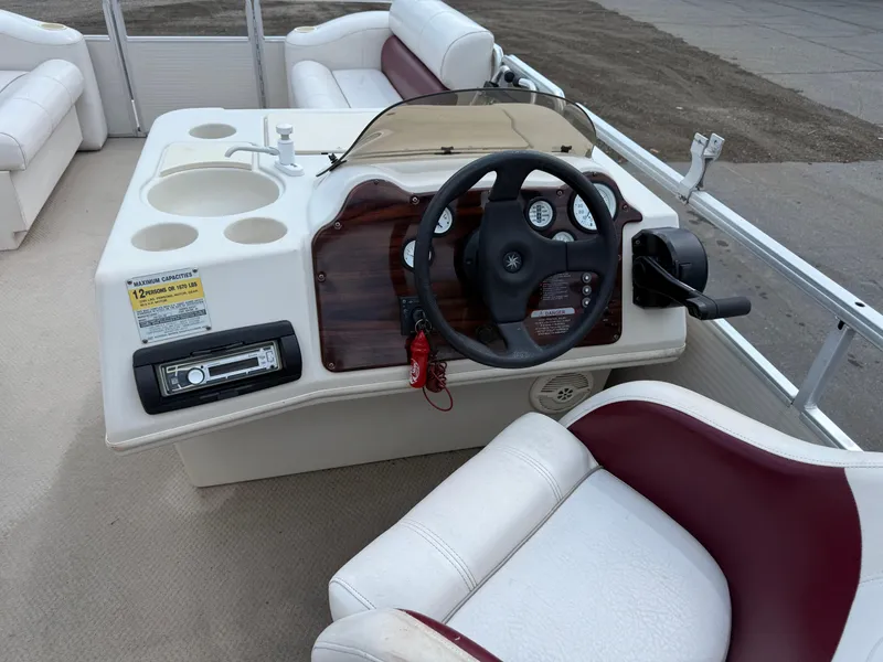 Slide: The Image of Steering console of a 2000 Harris 200 Super Sunliner pontoon boat with seating. - 13