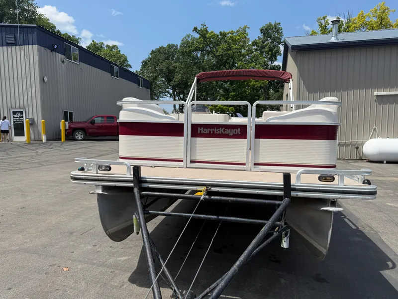 Slide: The Image of 2000 Harris 200 Super Sunliner pontoon boat parked outside industrial buildings. - 3