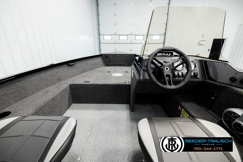 Slide: The Image of 2026 Lund 1650 Rebel XL SS boat interior with steering wheel and seating. - 15