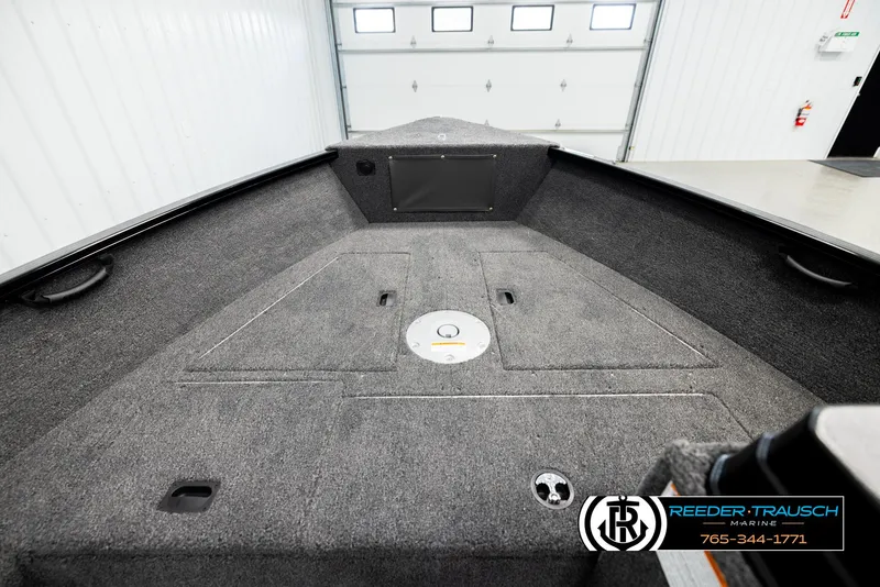 Slide: The Image of 2026 Lund 1650 Rebel XL SS boat interior with carpeted deck and storage compartments. - 16