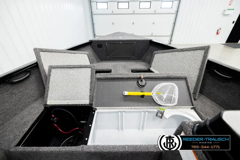 Slide: The Image of 2026 Lund 1650 Rebel XL SS boat interior with storage compartments and fishing net. - 17