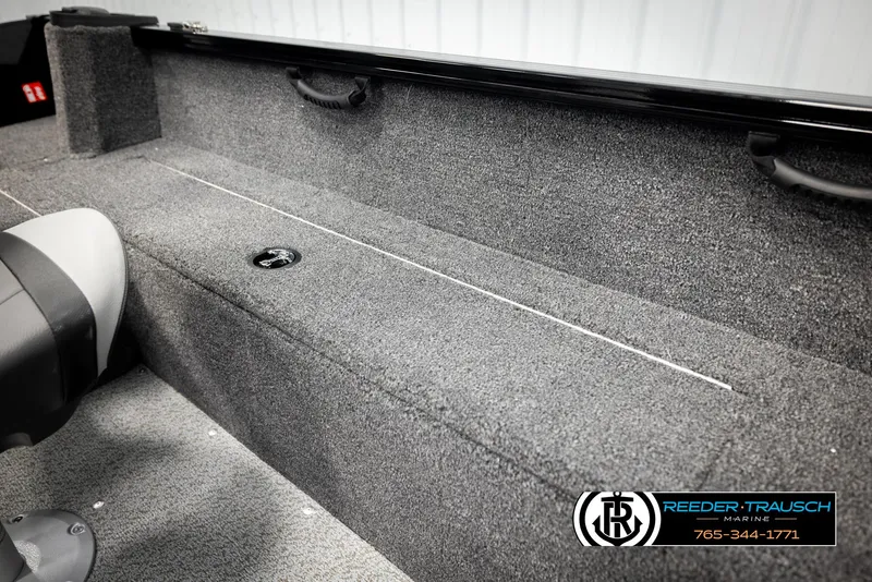 Slide: The Image of 2026 Lund 1650 Rebel XL SS boat interior with gray carpet and seating. - 20