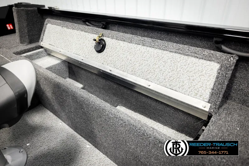 Slide: The Image of 2026 Lund 1650 Rebel XL SS boat interior with storage compartment and seat. - 21