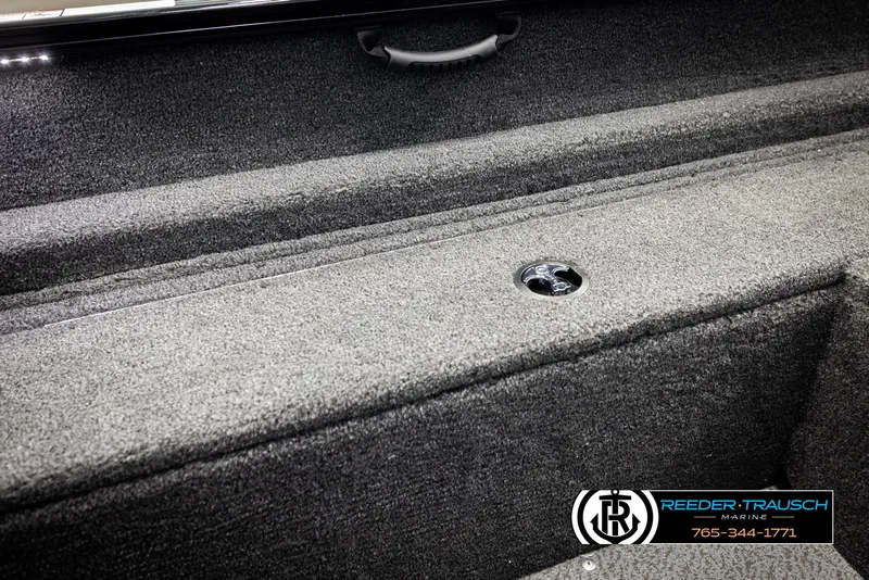 Slide: The Image of 2026 Lund 1650 Rebel XL SS boat interior with carpeted storage compartments. - 22
