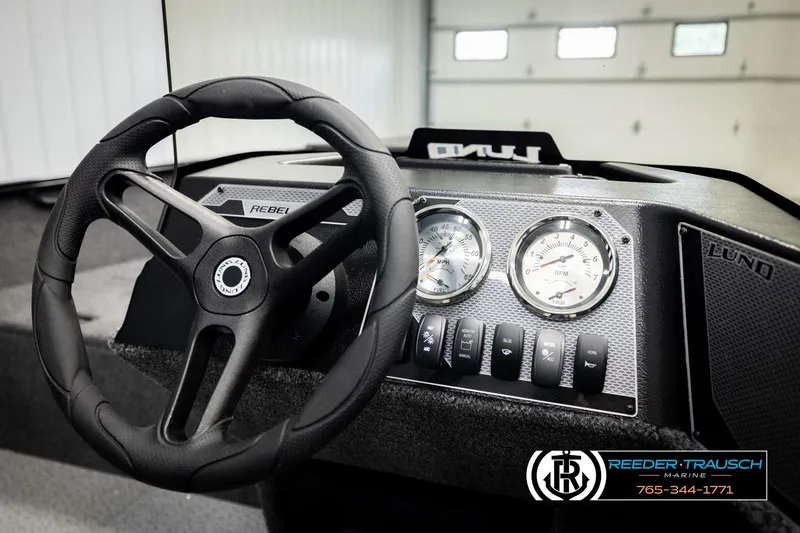 Slide: The Image of Steering wheel and dashboard of 2026 Lund 1650 Rebel XL SS boat, featuring gauges and controls. - 24