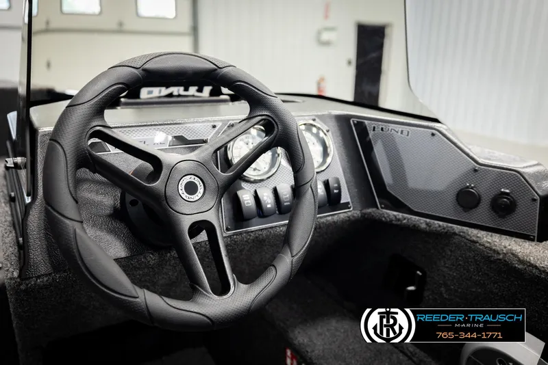 Slide: The Image of 2026 Lund 1650 Rebel XL SS boat dashboard with steering wheel and gauges. - 25