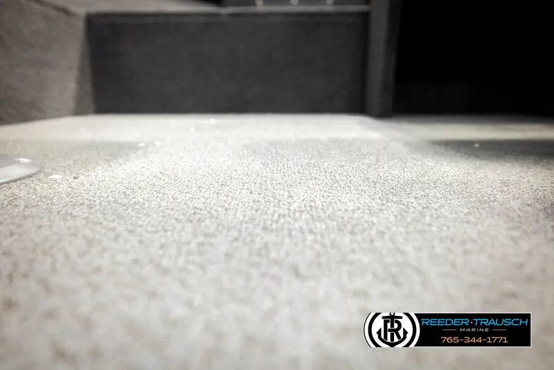 Slide: The Image of Carpeted interior of 2026 Lund 1650 Rebel XL SS boat, featuring Reeder-Trausch Marine logo. - 34
