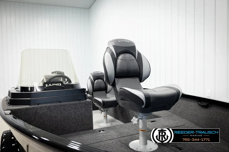 Slide: The Image of 2026 Lund 1650 Rebel XL SS boat interior with sleek seating and console, displayed indoors. - 36