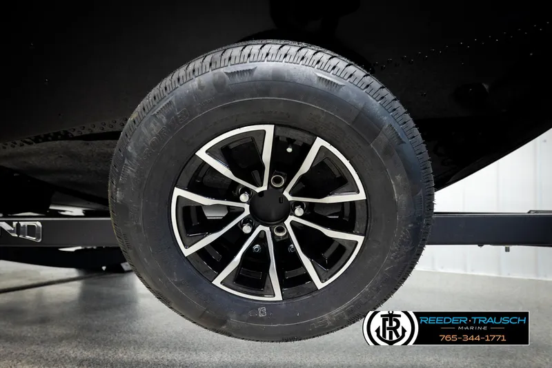 Slide: The Image of 2026 Lund 1650 Rebel XL SS trailer wheel, black alloy rim, Reeder-Trausch Marine logo. - 43