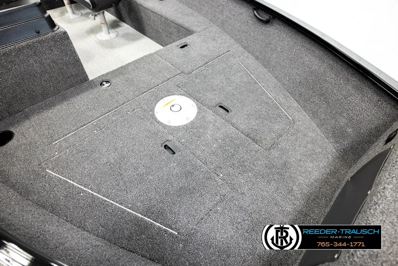 Slide: The Image of 2026 Lund 1650 Rebel XL SS boat interior with carpeted deck and storage compartments. - 7