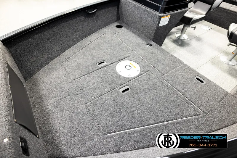 Slide: The Image of 2026 Lund 1650 Rebel XL SS boat interior with carpeted deck and seating. - 8