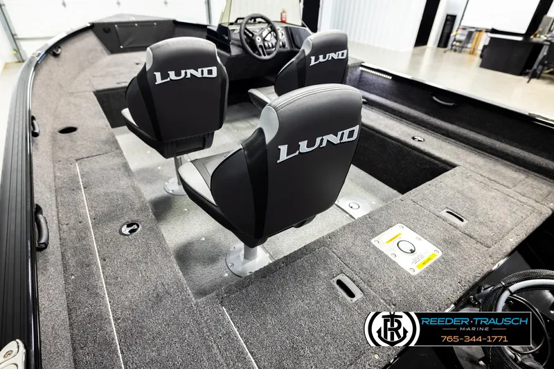 Slide: The Image of 2026 Lund 1650 Rebel XL SS boat interior with two branded seats and carpeted flooring. - 9