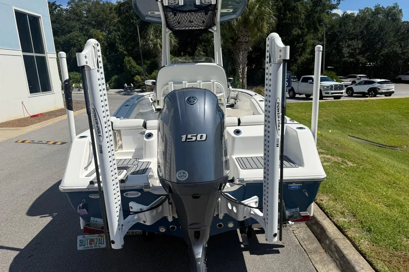 Slide: The Image of 2023 Tidewater 210 LXF boat with a 150 horsepower engine, parked outdoors. - 18