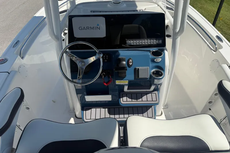 Slide: The Image of 2023 Tidewater 210 LXF boat console with Garmin display and steering wheel. - 19