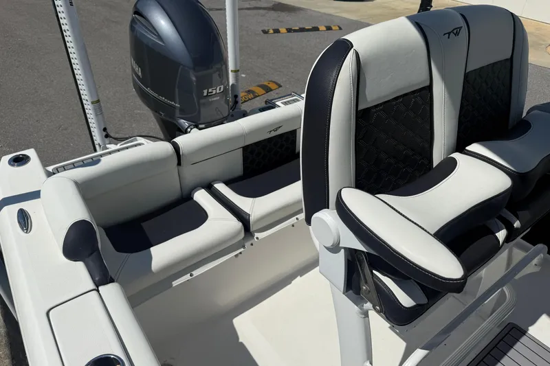 Slide: The Image of 2023 Tidewater 210 LXF boat interior with Yamaha 150 engine, featuring stylish seating. - 21