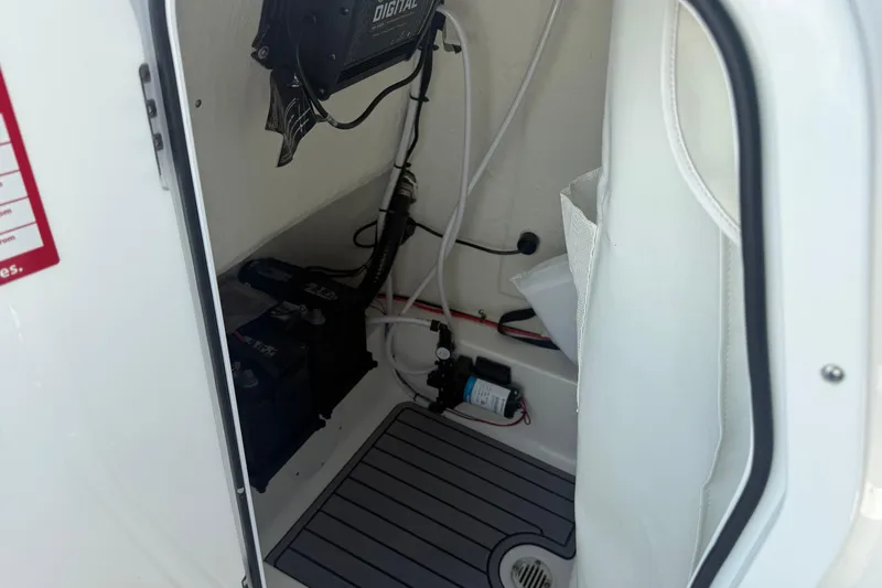 Slide: The Image of Interior view of 2023 Tidewater 210 LXF boat, showcasing electrical components and wiring. - 22