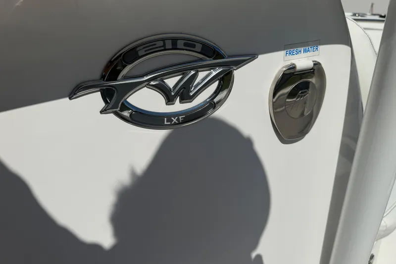 Slide: The Image of 2023 Tidewater 210 LXF boat emblem and fresh water access. - 23