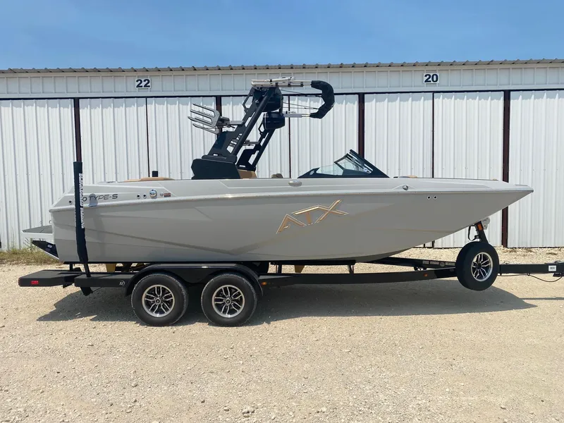 The Image of 2026 ATX Surf Boats 20 Type-S on trailer, parked outside storage units. - 0