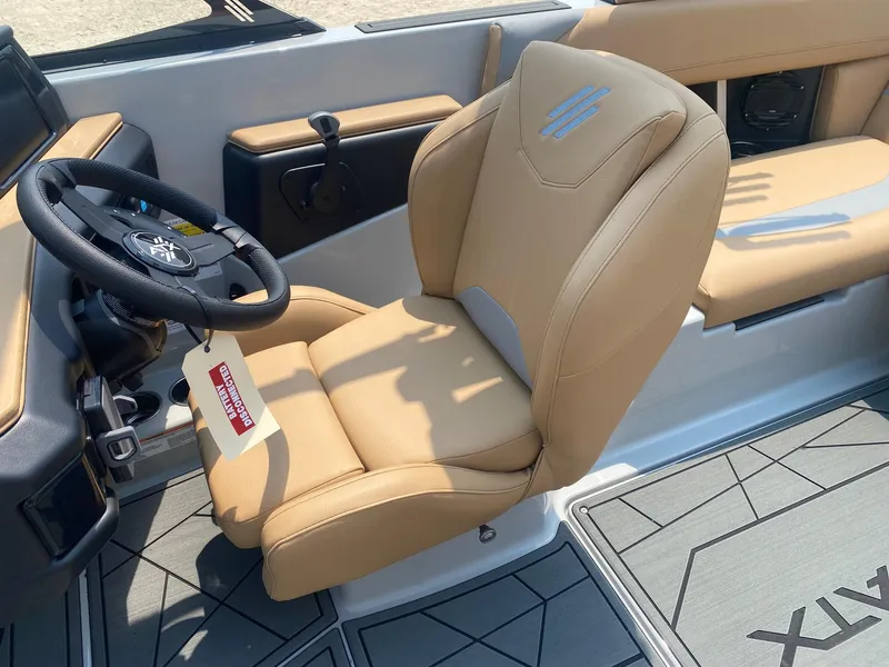 Slide: The Image of 2026 ATX Surf Boats 20 Type-S interior with tan seating and steering wheel. - 11