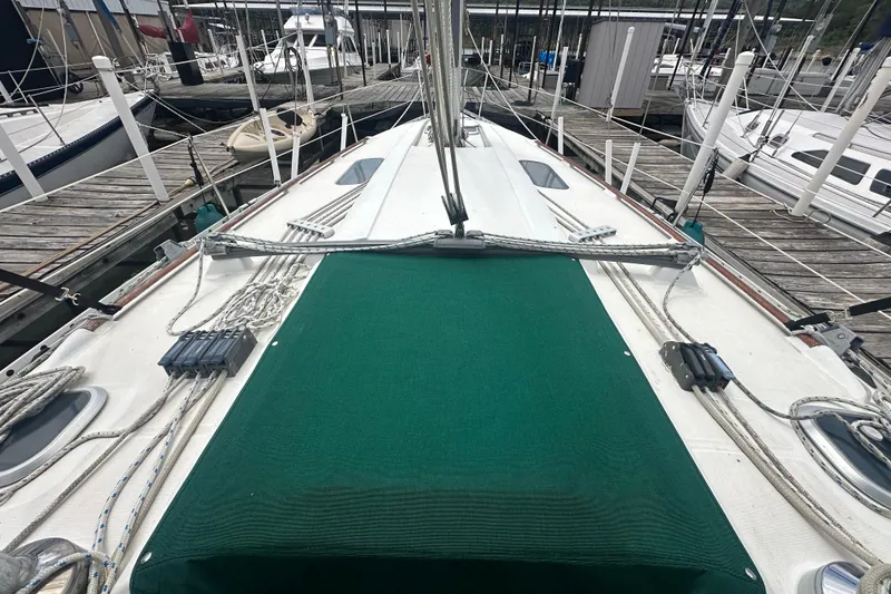 Slide: The Image of 1998 Beneteau Oceanis 352 sailboat deck with green cover at marina. - 13