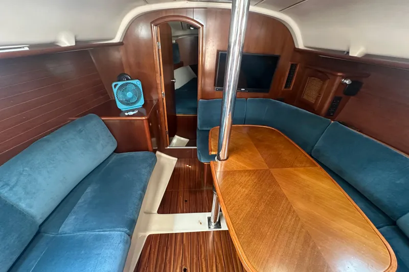 Slide: The Image of Interior of 1998 Beneteau Oceanis 352 sailboat with wood finish and blue seating. - 16