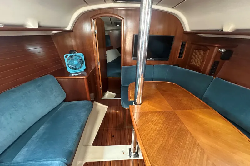 Slide: The Image of Interior of 1998 Beneteau Oceanis 352 sailboat with wood finish and blue seating. - 17