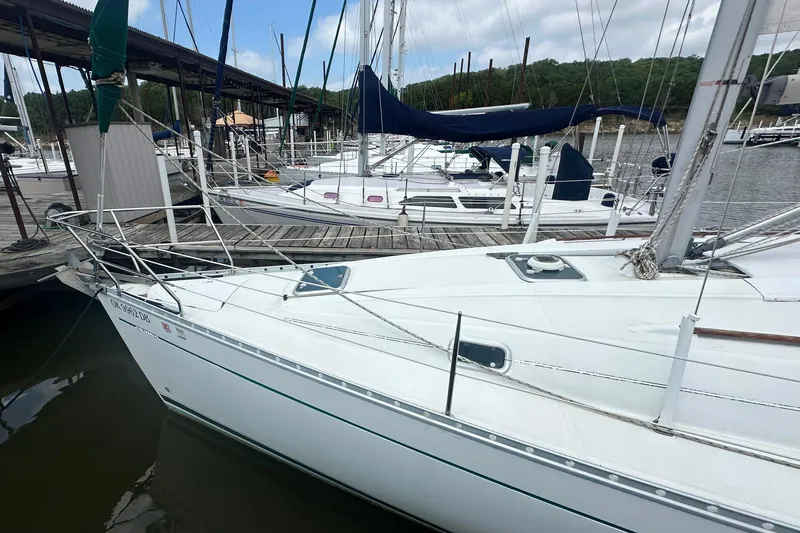Slide: The Image of 1998 Beneteau Oceanis 352 sailboat docked at marina, surrounded by other boats. - 2