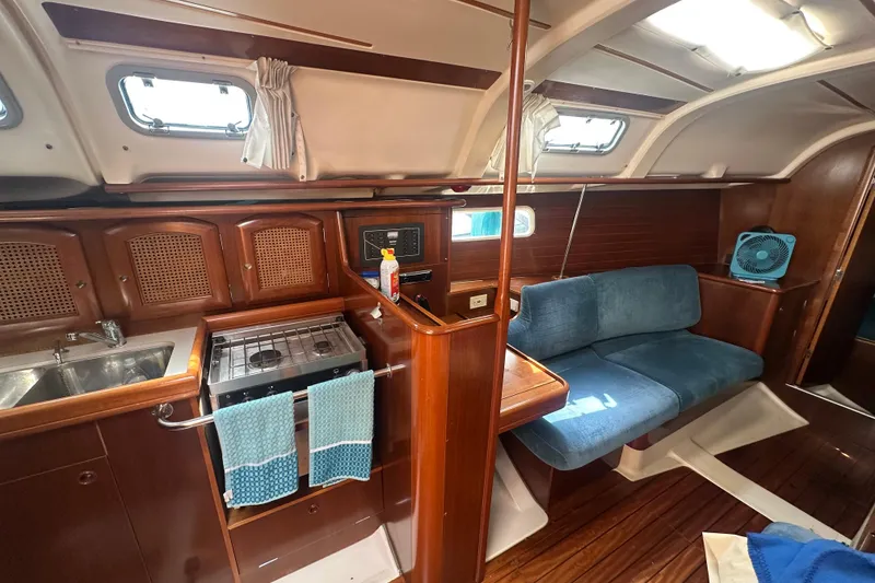 Slide: The Image of Interior of 1998 Beneteau Oceanis 352 sailboat with kitchen and seating area. - 21