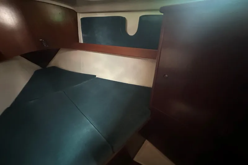 Slide: The Image of Interior cabin of 1998 Beneteau Oceanis 352 sailboat with wooden finish and cushioned seating. - 26