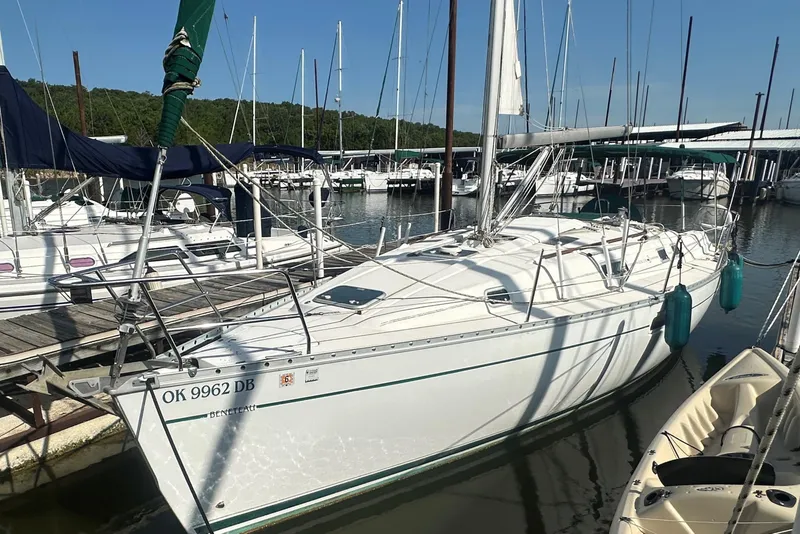 Slide: The Image of 1998 Beneteau Oceanis 352 sailboat docked at marina, surrounded by other boats. - 4