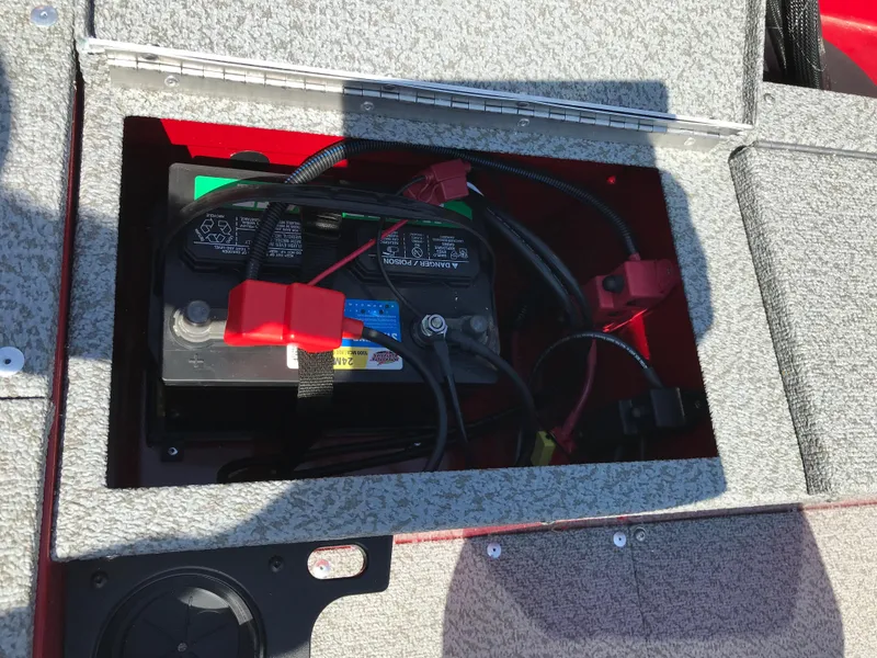 Slide: The Image of 2026 Lund 1800 Explorer SS boat dashboard with steering wheel and gauges in a marina setting. - 11