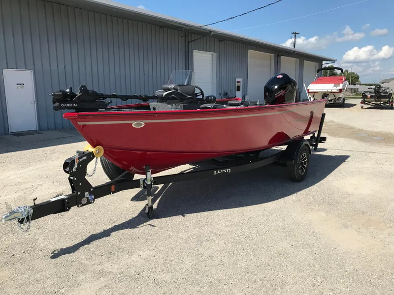 Slide: The Image of 2026 Lund 1800 Explorer SS boat interior with steering console and seating. - 13