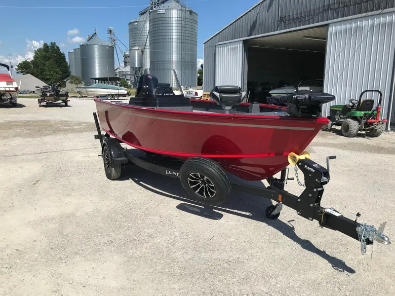 Slide: The Image of 2026 Lund 1800 Explorer SS boat with Garmin trolling motor, parked outdoors. - 15