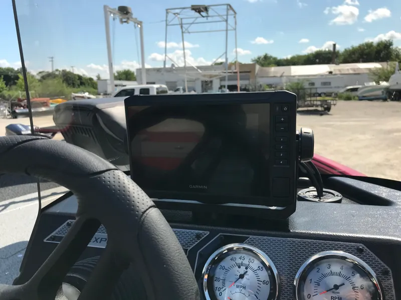 Slide: The Image of 2026 Lund 1800 Explorer SS dashboard with Garmin device and steering wheel. - 19