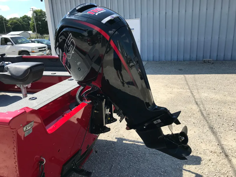 Slide: The Image of 2026 Lund 1800 Explorer SS boat with Mercury Pro XS outboard motor, parked outdoors. - 6