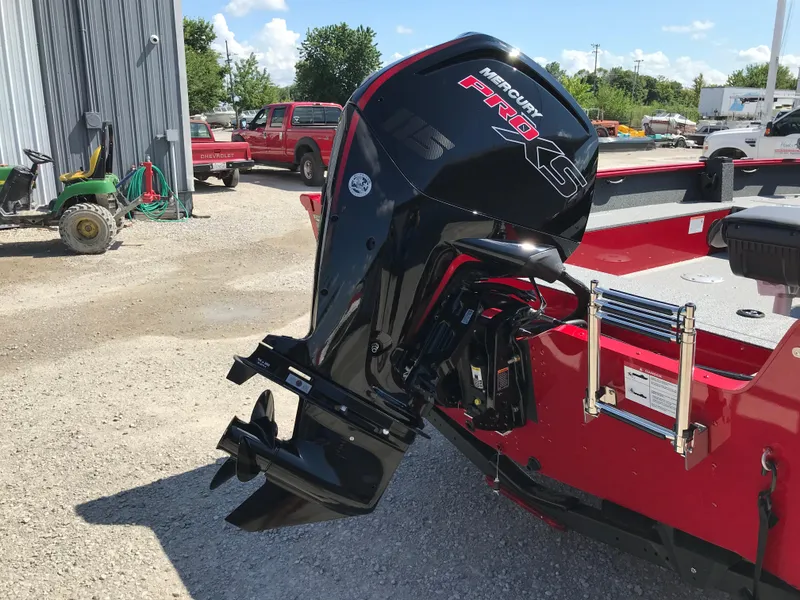 Slide: The Image of 2026 Lund 1800 Explorer SS boat in a marina with parked vehicles and boats. - 7