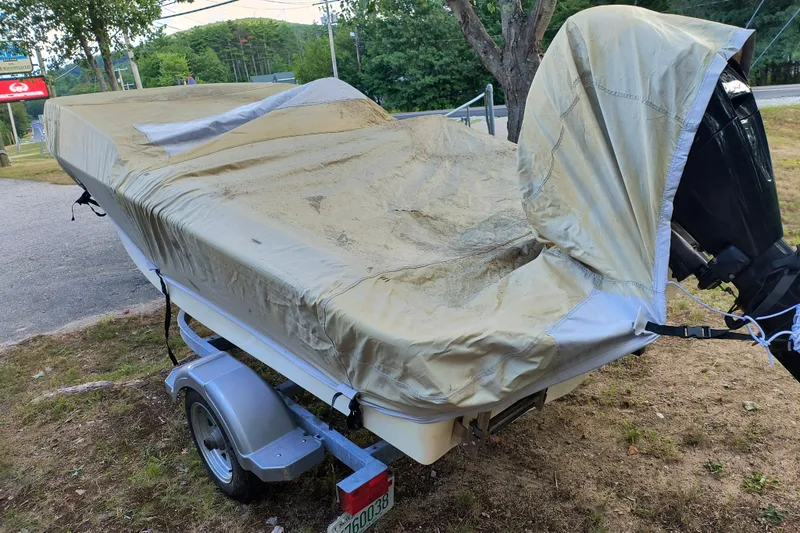 Slide: The Image of Covered 2016 Boston Whaler 130 Super Sport on trailer, parked outdoors. - 11