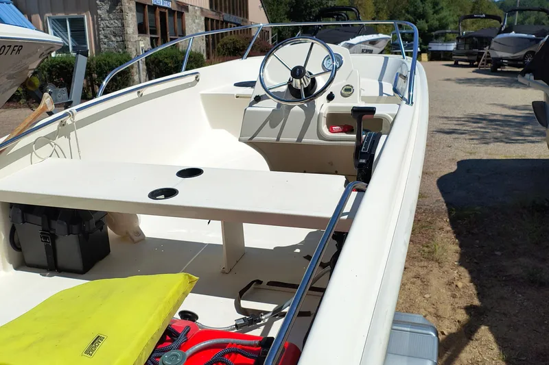 Slide: The Image of 2016 Boston Whaler 130 Super Sport boat interior with steering wheel and seating. - 4